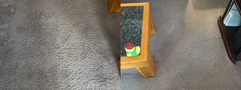 Light gray carpet in a living room beside an oak and glass end table